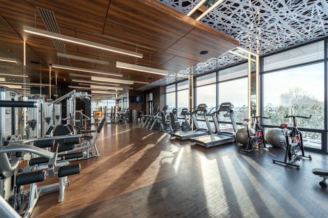 Gym room featuring workout machines and natural light from windows