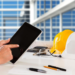 Hand holding tablet on table with hard hats